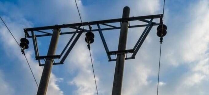 Low Angle View Of telegraph poles against blue sky. Low Angle View Of telegraph poles against blue sky.